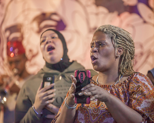 Photograph of two people singing