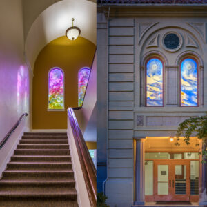 Interior view of building with multi-color windows reflecting colorful shadows on wall