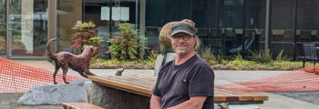 <h3>2022, Brade Rude poses with several of his bronze sculptures part of his work A Common Bond outside of Oregon State University Magruder Hall</h3>
