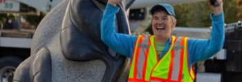 <h3>2024, Sue Taves celebrating with her finished sculpture Interconnected being installed at North Valley Complex in Wilsonville</h3>