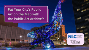 A large colorful whale sculpture placed outside with building in the back and the NLC and PAA logo placed on top.
