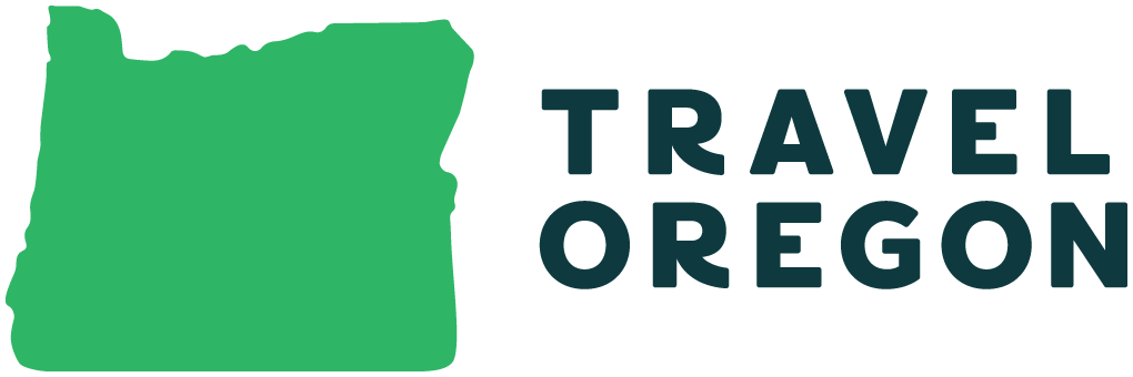Green image in the shape of the state of oregon with bold text that reads Travel Oregon